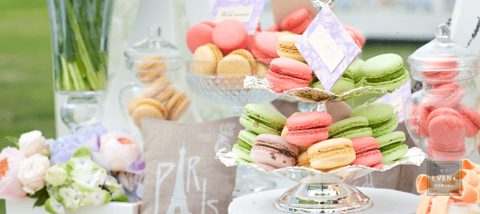 wedding snack table with stands filled with colorful macarons