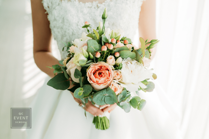 bride's midriff, hands holding bouquet
