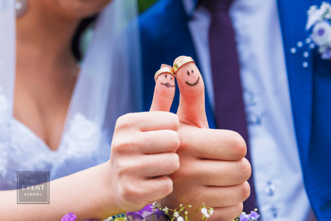 Bride and groom showing thumbs up