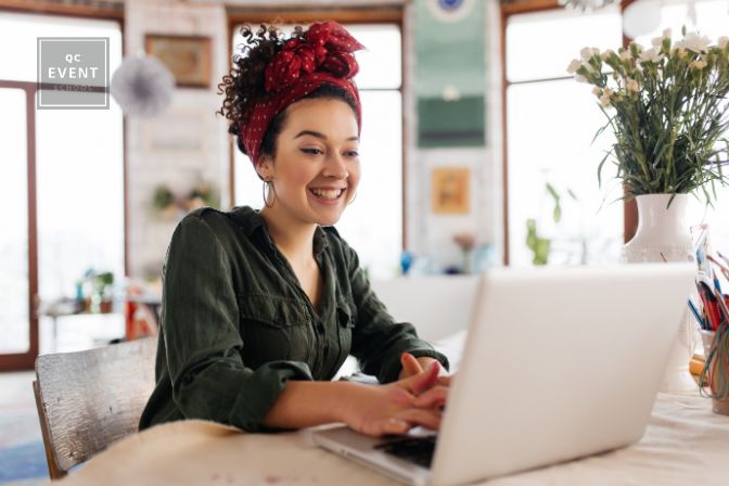 Woman smiling and looking at laptop