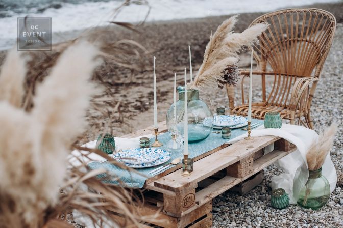 Decorated table in boho style on the beach for two people