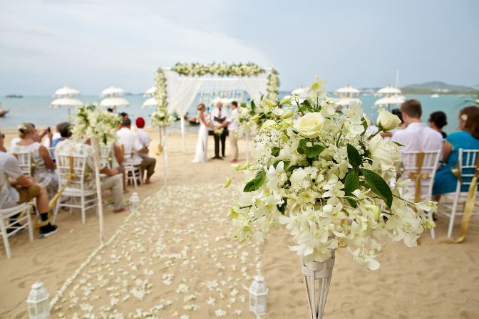 soft focus of beautiful flower decoration in the beach wedding ceremony. Wedding planning business.