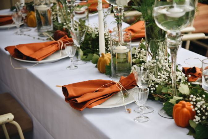 The Wedding Decor Rustic Style. Table Decoration Setting with Flowers Ivy and Pumpkins. Fall wedding trends.