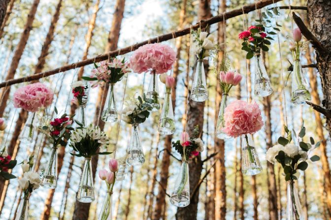 Wedding flowers decoration arch in the forest. The idea of a wedding flower decoration. wedding concept in nature. Event decorating article.
