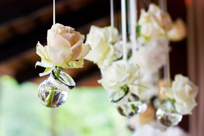 Flowers in bulbs hang in a wedding party.