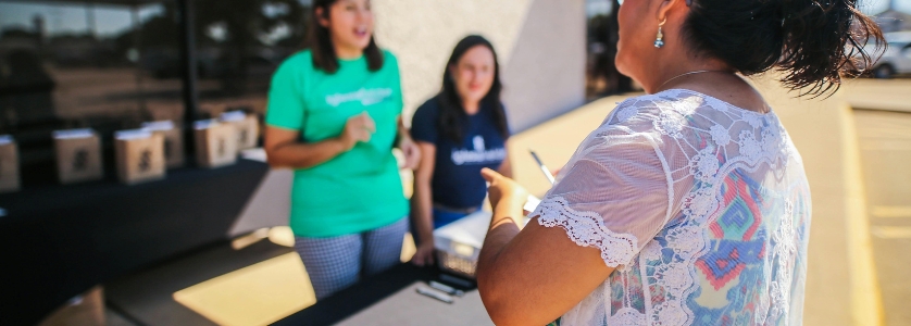 Event planner speaking to volunteers at an event venue